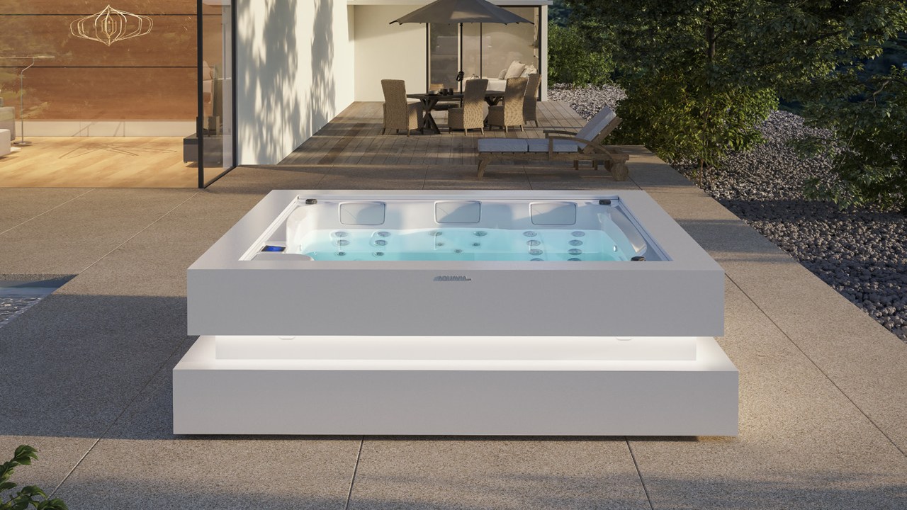 Spa Serenity en blanco con base iluminada en terraza al atardecer